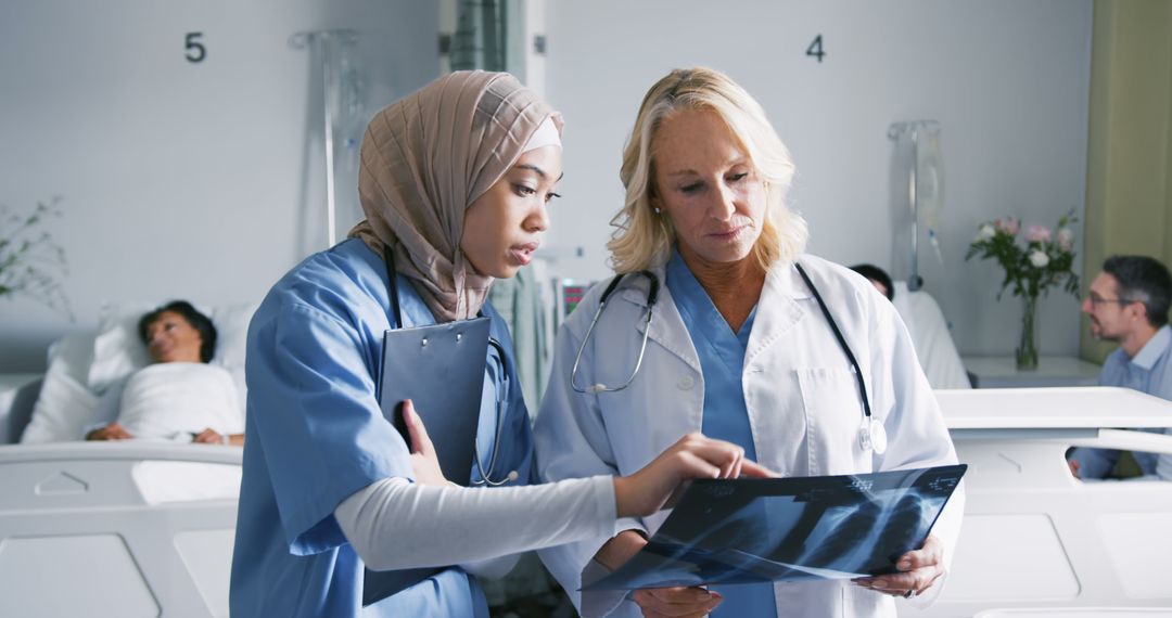 Diverse Female Doctors Reviewing X-Ray in Hospital Ward - Free Images, Stock Photos and Pictures on Pikwizard.com