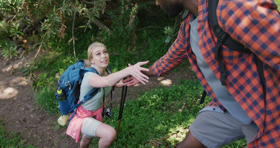 Diverse Couple Enjoys Nature Hike with Backpacks in Lush Forest