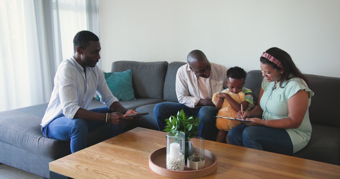 Diverse Family Relaxing on Couch with Tablet at Home