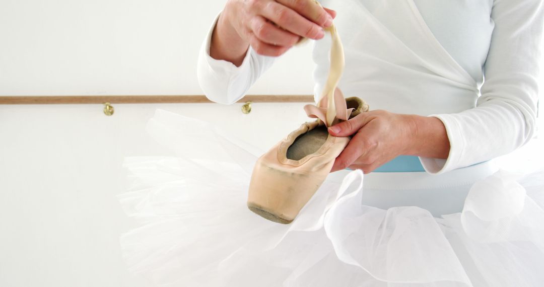 Ballerina Tying Pointe Shoe for Dance Performance