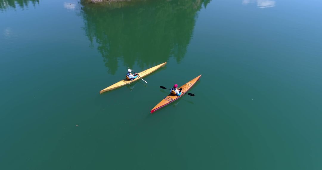 Two People Kayaking on Serene Lake with Clear Skies - Free Images, Stock Photos and Pictures on Pikwizard.com