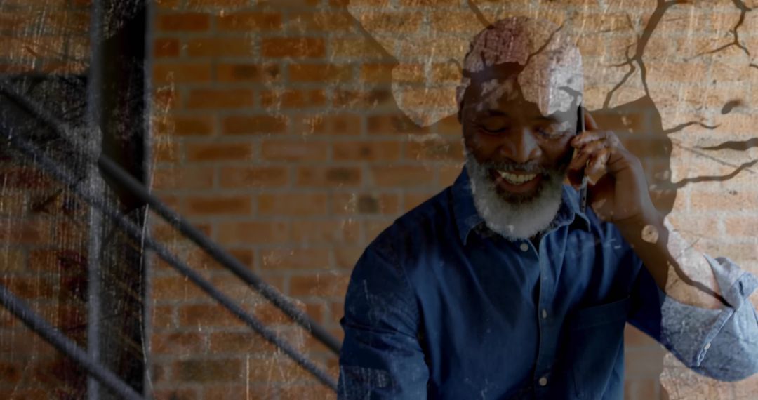 Stylish Senior Man Conversing on Smartphone in Industrial Loft