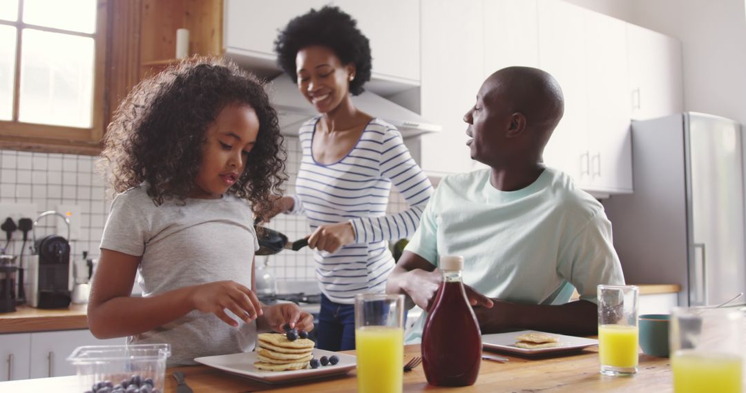 Happy African American Family Enjoying Breakfast Together in Kitchen - Free Images, Stock Photos and Pictures on Pikwizard.com