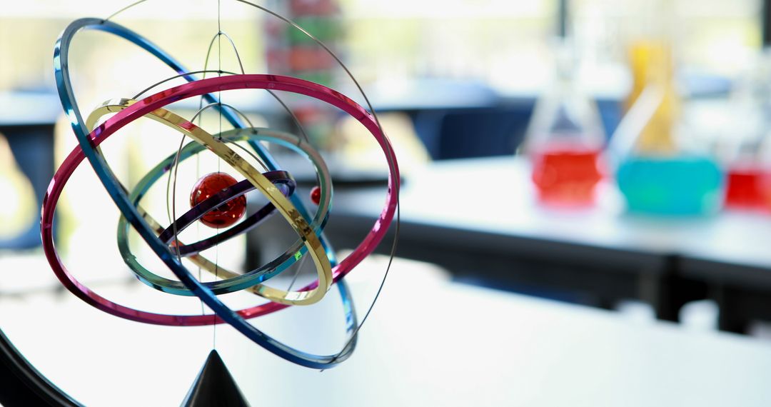 A model of an atom hangs in focus, symbolizing scientific education, with copy space - Free Images, Stock Photos and Pictures on Pikwizard.com
