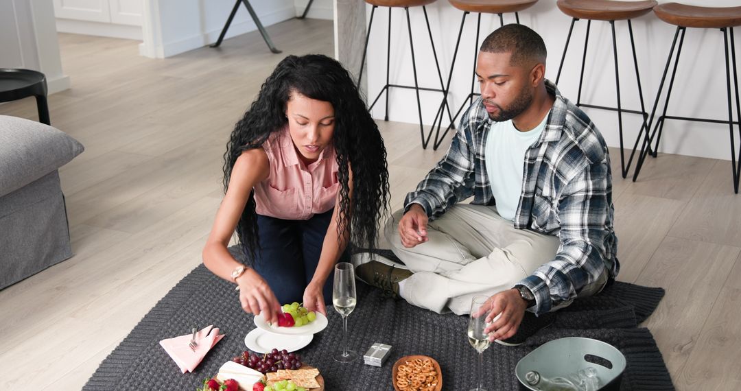 Couple Celebrating Together with Wine and Snacks at Home