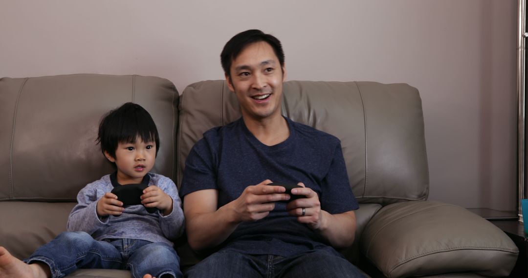 Father and Child Bonding While Playing Video Games - Free Images, Stock Photos and Pictures on Pikwizard.com