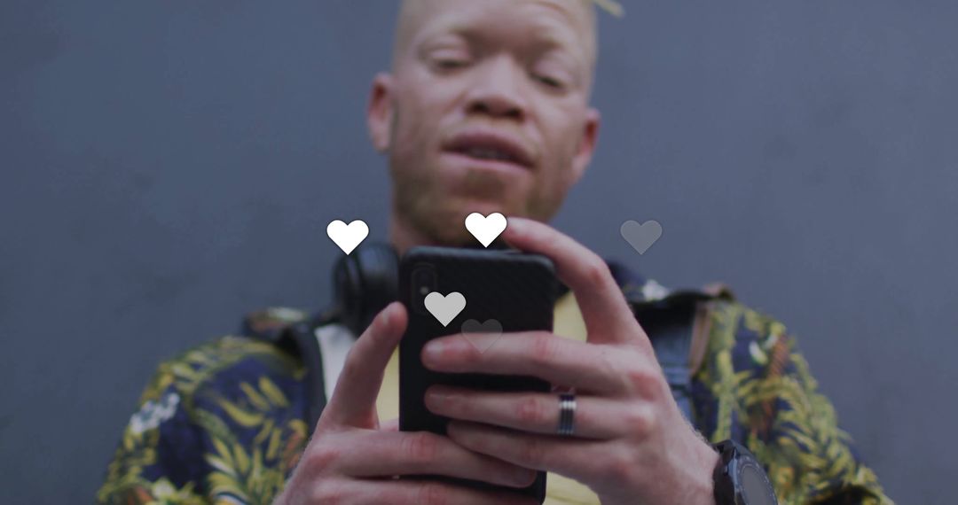 Man Engaged with Social Media on Smartphone Showing Floating Hearts