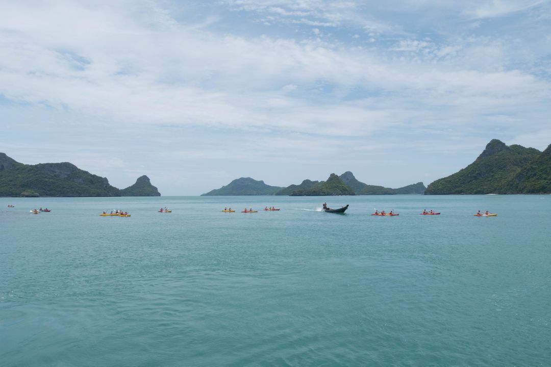 Tourists Kayaking in Scenic Ocean with Island Backdrop - Free Images, Stock Photos and Pictures on Pikwizard.com