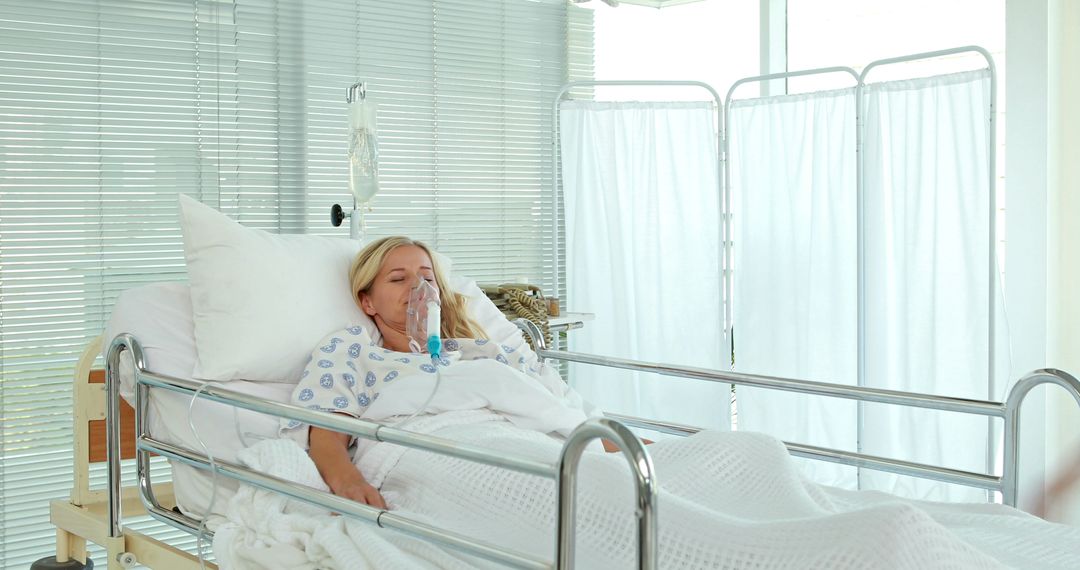 Female Patient Lying in Hospital Bed with Oxygen Mask - Free Images, Stock Photos and Pictures on Pikwizard.com