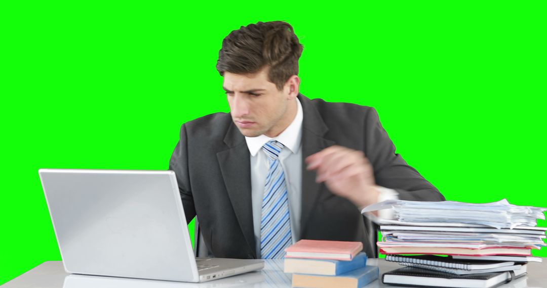 Businessman Working on Laptop at Desk with Green Screen Background - Free Images, Stock Photos and Pictures on Pikwizard.com