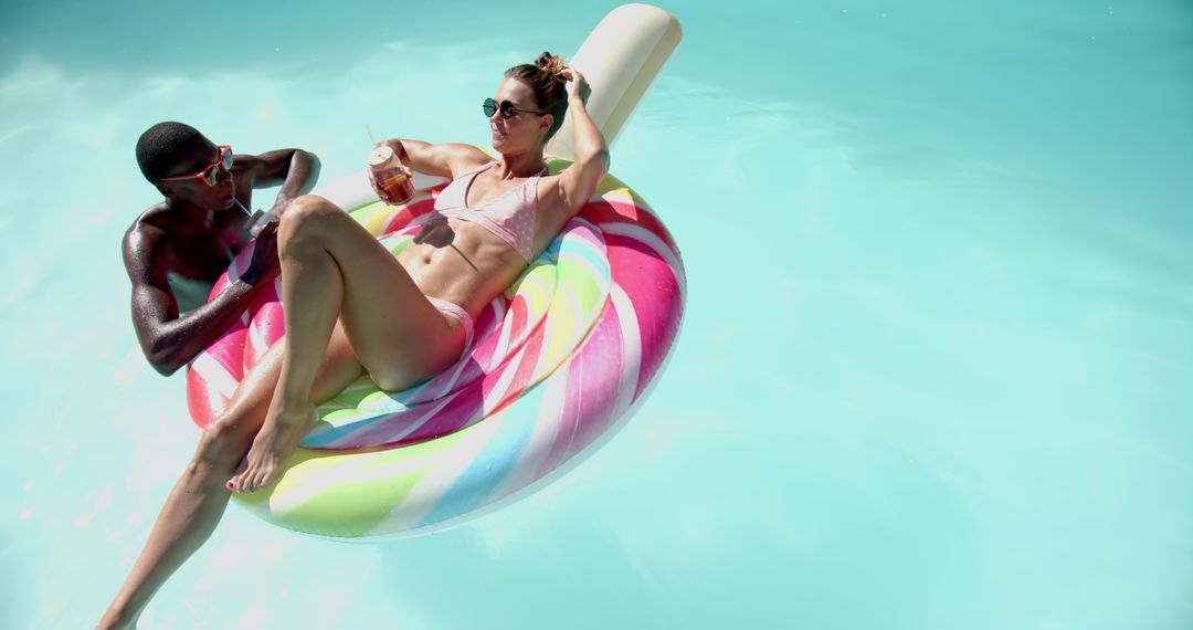 Diverse Couple Enjoying Refreshing Day on Inflatable Pool Float