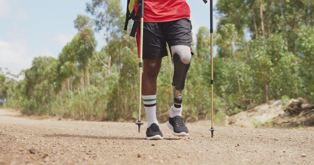 Paralympic Athlete with Prosthetic Leg Walking on Nature Trail - Free Images, Stock Photos and Pictures on Pikwizard.com