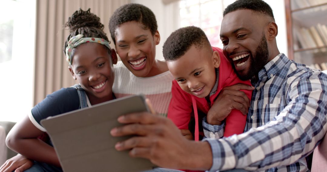 Happy African American Family Using Tablet at Home - Free Images, Stock Photos and Pictures on Pikwizard.com