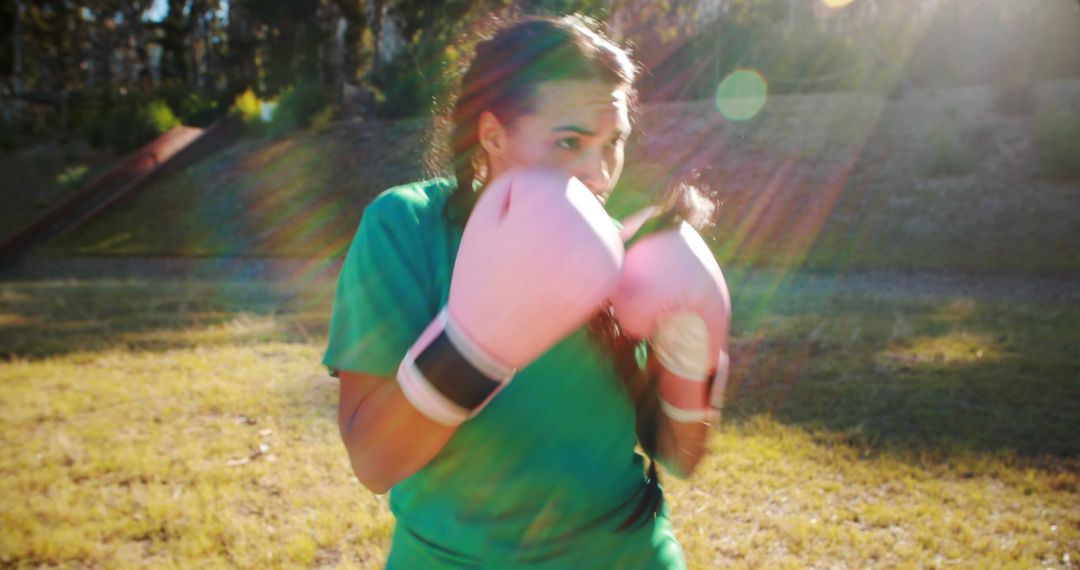 Young Female Boxer Training Outdoors with Pink Gloves - Free Images, Stock Photos and Pictures on Pikwizard.com