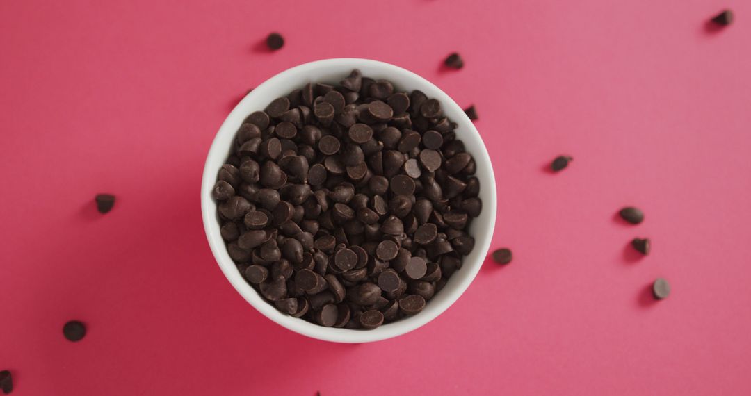 Dark Chocolate Chips in White Bowl on Pink Background - Free Images, Stock Photos and Pictures on Pikwizard.com