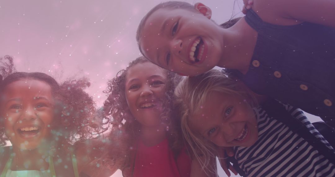 Joyful Diverse Schoolgirls with Light Particles Overlay