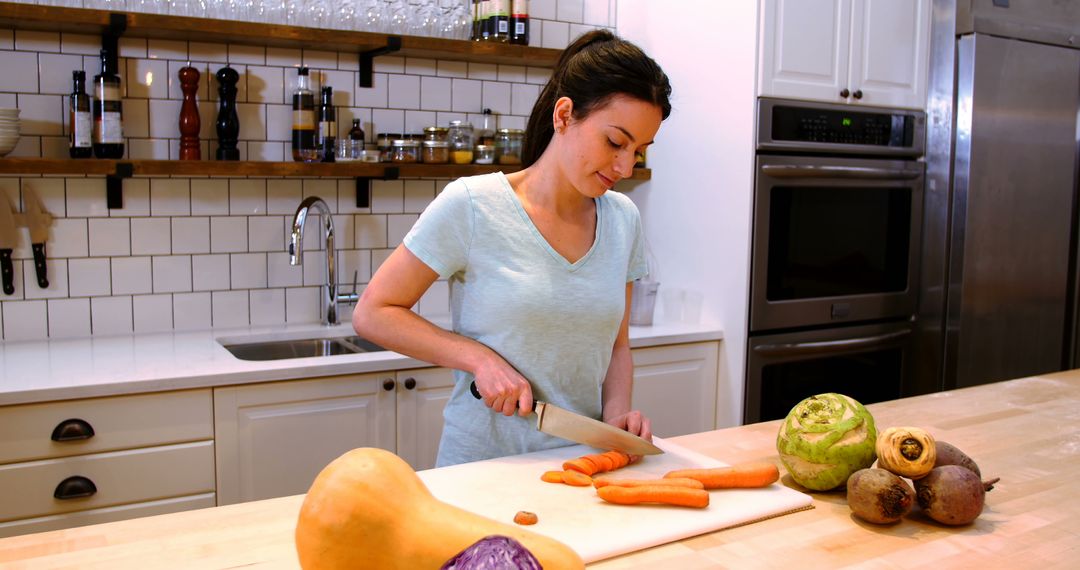 Woman Preparing Carrot in Modern Kitchen with Fresh Vegetables on Counter - Free Images, Stock Photos and Pictures on Pikwizard.com