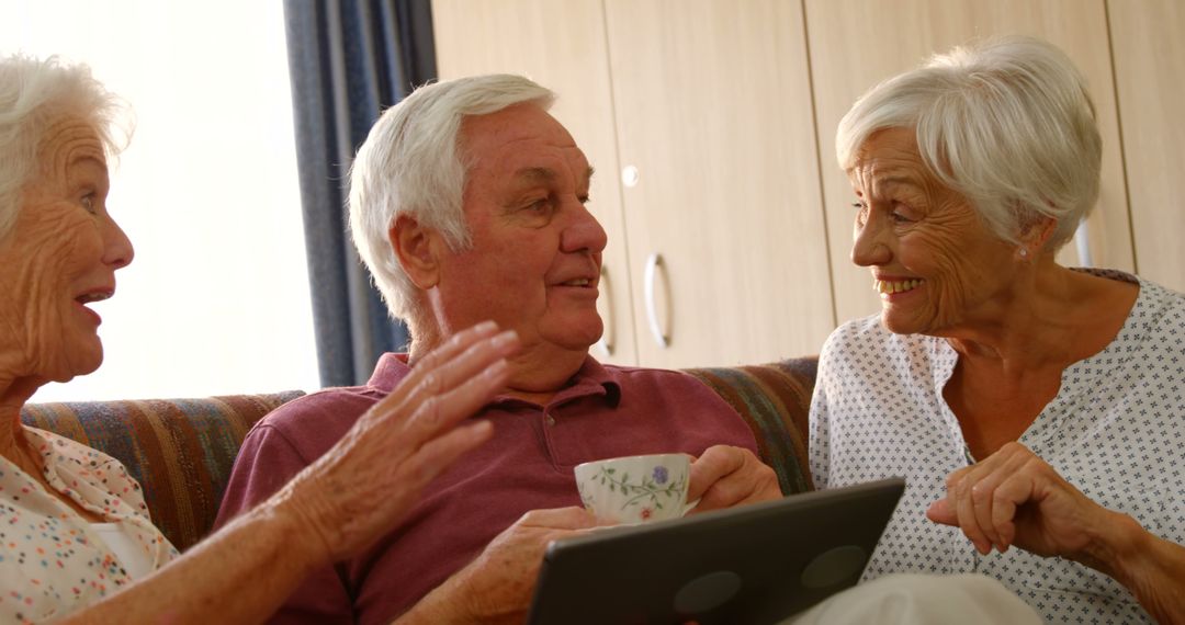 Seniors Socializing Over Tea and Tablet in Nursing Home - Free Images, Stock Photos and Pictures on Pikwizard.com