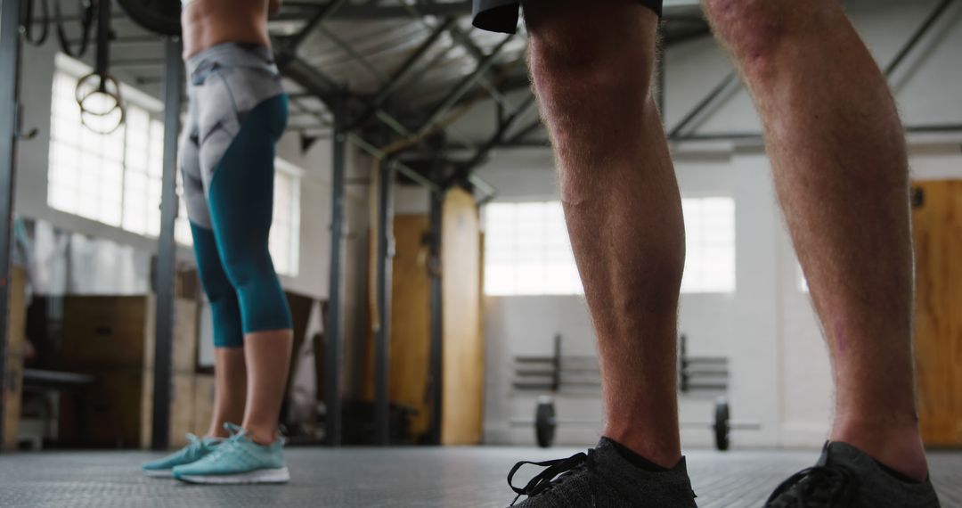 Determined Athletes in Gym Displaying Fitness Apparel
