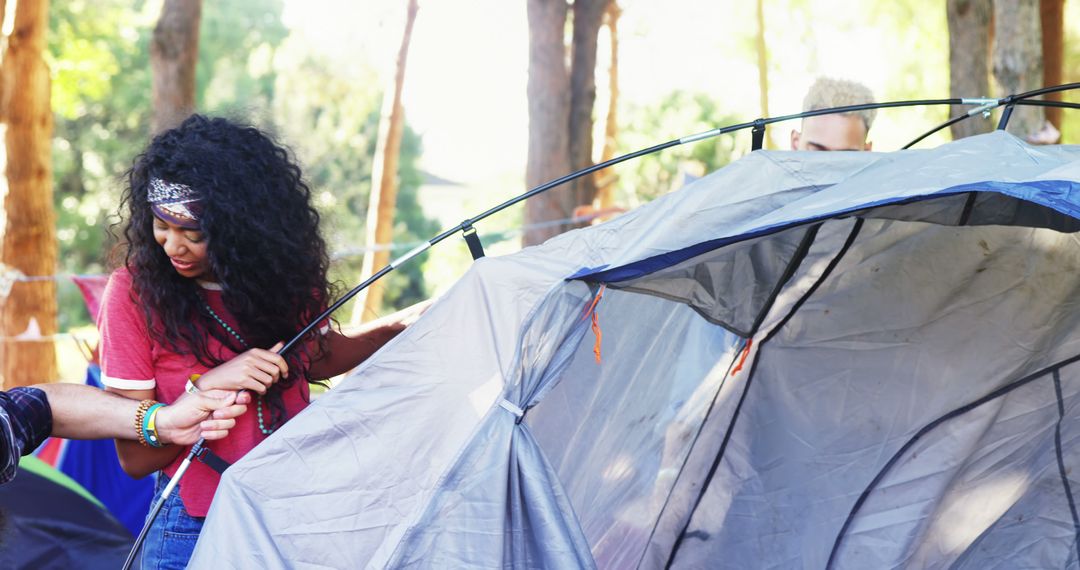 Young People Setting Up Tent in Forest - Free Images, Stock Photos and Pictures on Pikwizard.com