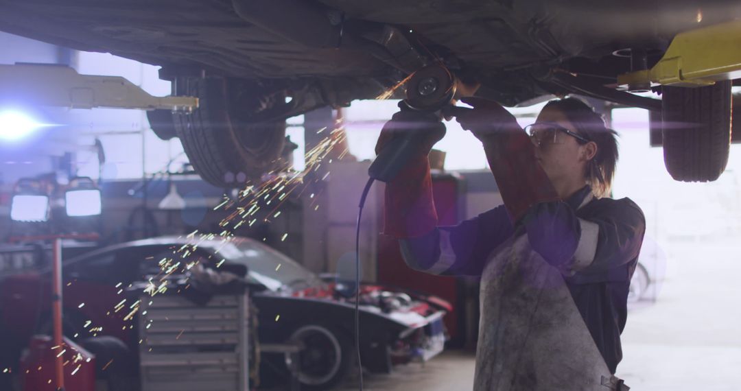 Female Mechanic Using Grinder on Car in Auto Workshop - Free Images, Stock Photos and Pictures on Pikwizard.com