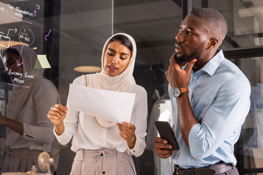 Diverse Team Collaborating with Glass Board and Technology