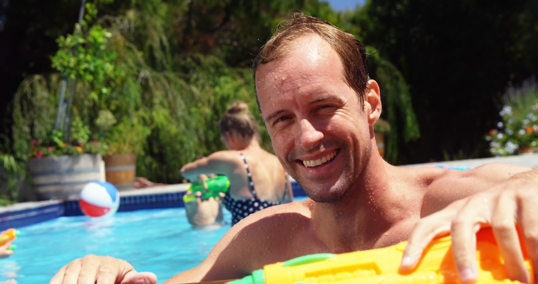 Portrait of man smiling near swimming pool on a sunny day - Free Images, Stock Photos and Pictures on Pikwizard.com