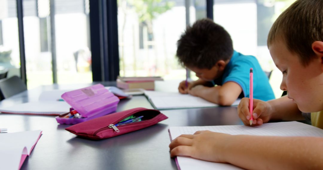 Children Studying Diligently in Classroom Setting
