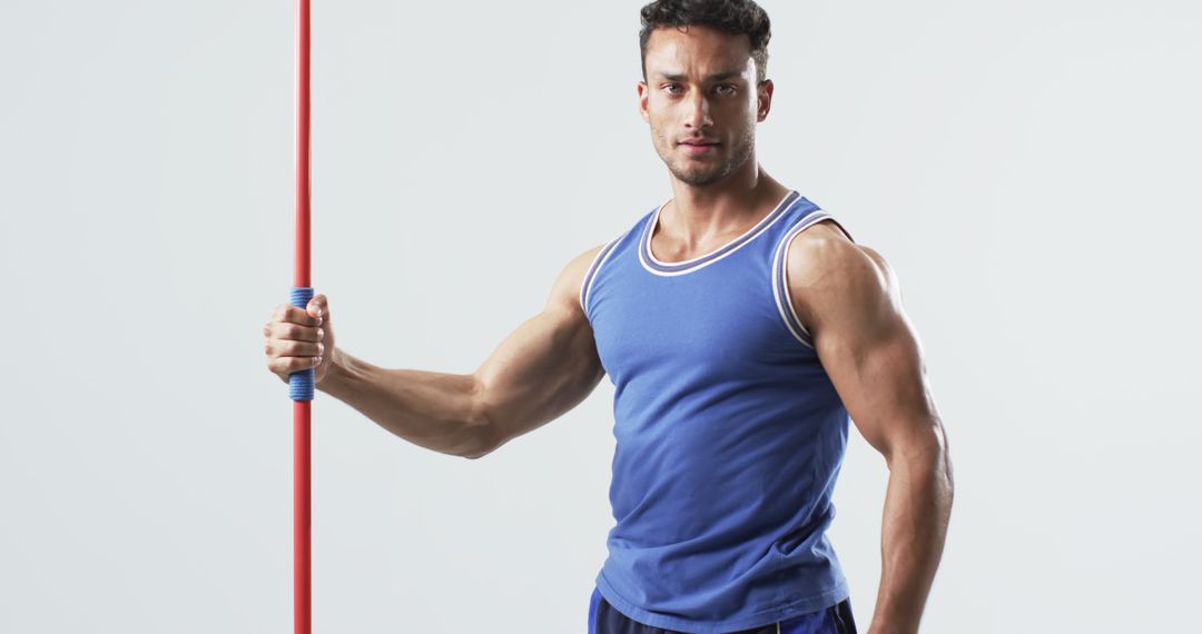 Muscular Athlete Holding Javelin Showcasing Strength