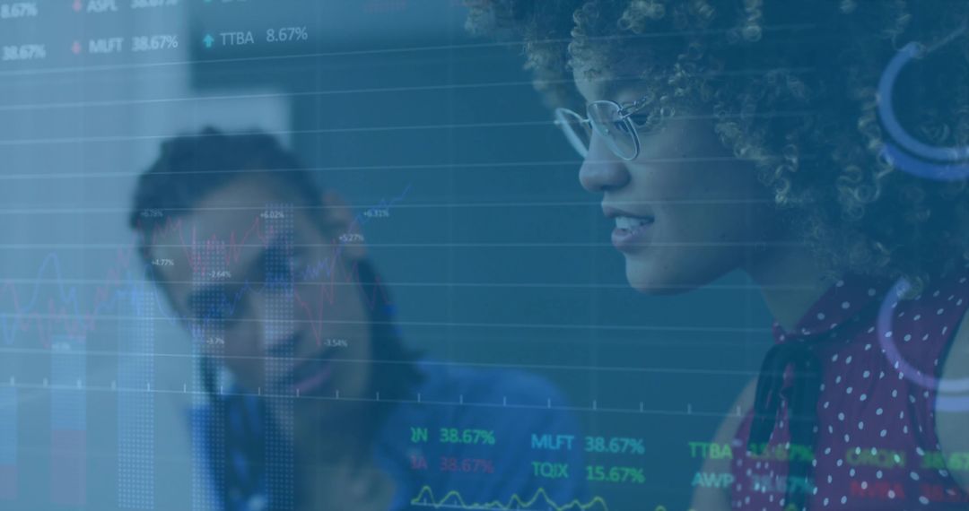 Female Financial Analysts Examining Digitized Stock Data Overlay