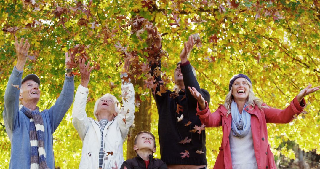 Multi-Generational Family Enjoying Autumn Leaves Outdoors - Free Images, Stock Photos and Pictures on Pikwizard.com