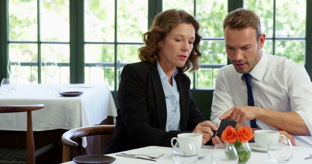 Colleagues Discussing Project at Restaurant Table
