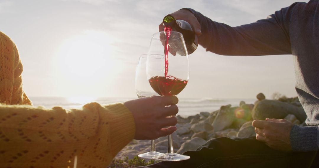 Couple Enjoying Wine at Beach Sunset, Relaxation and Romance - Free Images, Stock Photos and Pictures on Pikwizard.com