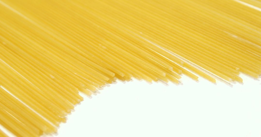 Close-Up of Uncooked Spaghetti Pasta Against White Background - Free Images, Stock Photos and Pictures on Pikwizard.com