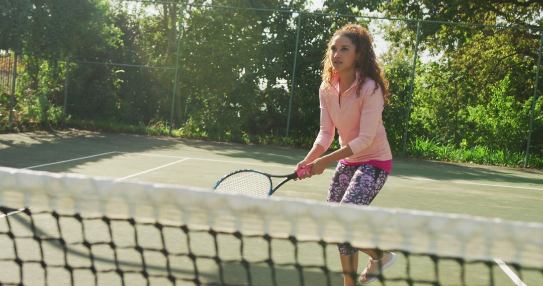 Woman Concentrating While Playing Tennis on Outdoor Court - Free Images, Stock Photos and Pictures on Pikwizard.com