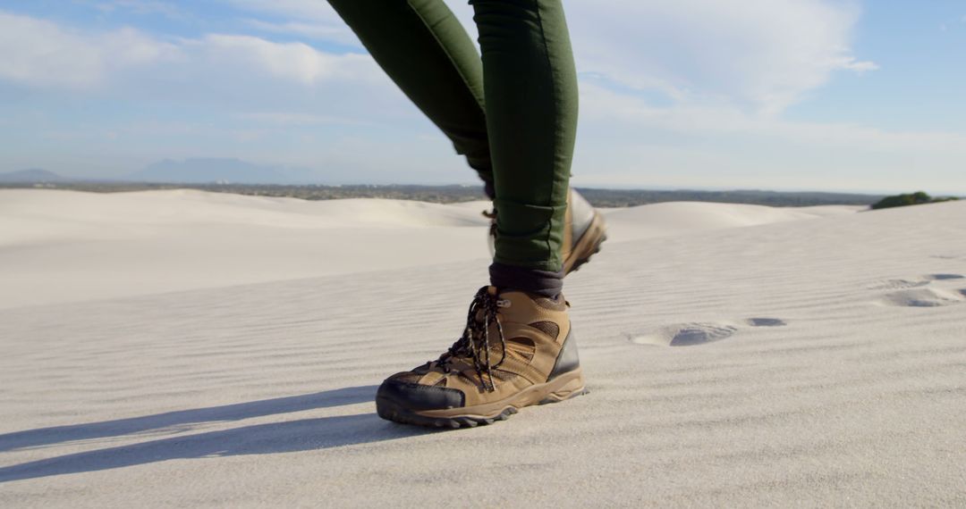 Person Hiking Through Sand Dunes in Outdoor Boots - Free Images, Stock Photos and Pictures on Pikwizard.com