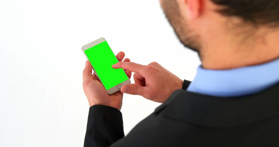 Businessman Engaging with Smartphone with Green Screen