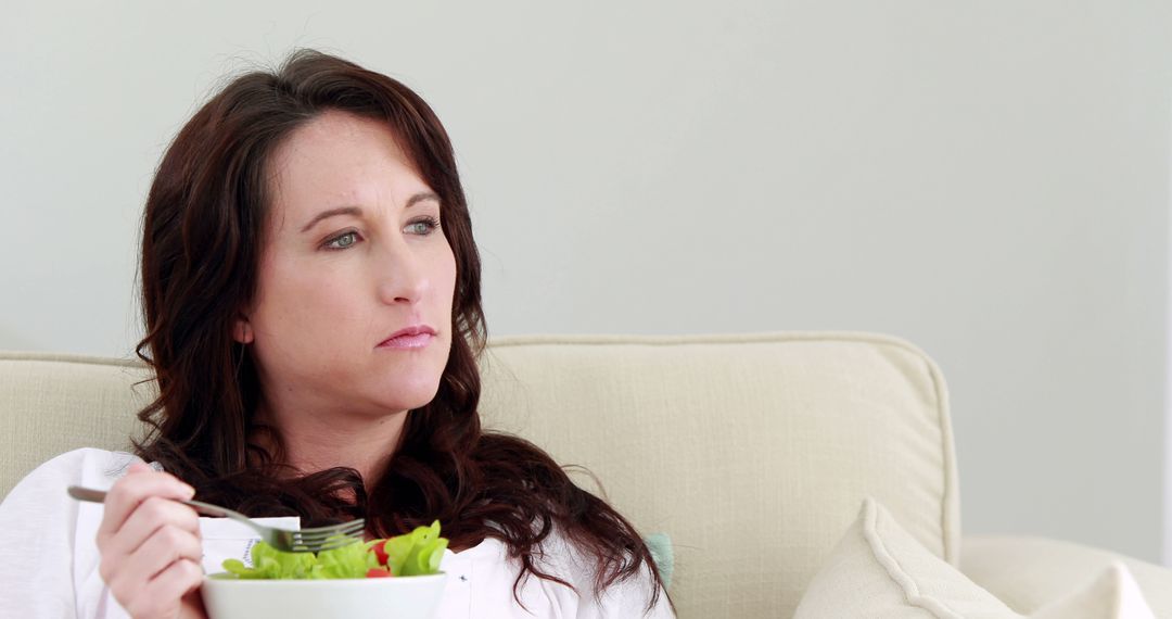 Contemplative Woman Eating Healthy Salad at Home - Free Images, Stock Photos and Pictures on Pikwizard.com