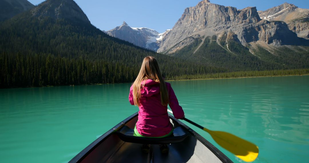 Woman Canoeing on Mountain Lake with Scenic View - Free Images, Stock Photos and Pictures on Pikwizard.com