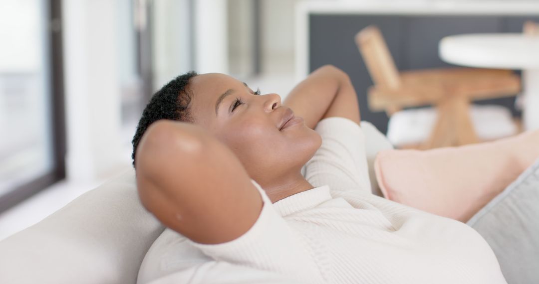 Relaxed African American Woman Resting on Sofa at Home - Free Images, Stock Photos and Pictures on Pikwizard.com