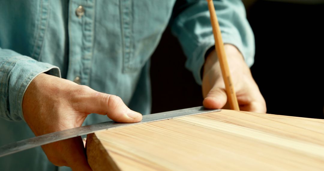 Close-Up of Carpenter Measuring Wood with Ruler - Free Images, Stock Photos and Pictures on Pikwizard.com