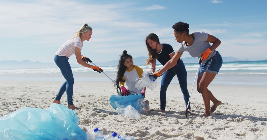 Diverse Group of Women Collecting Trash on Beach for Environmental Cleanup - Free Images, Stock Photos and Pictures on Pikwizard.com