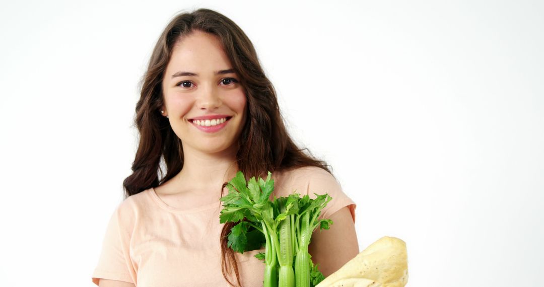 Smiling Young Woman Holding Fresh Vegetables - Free Images, Stock Photos and Pictures on Pikwizard.com