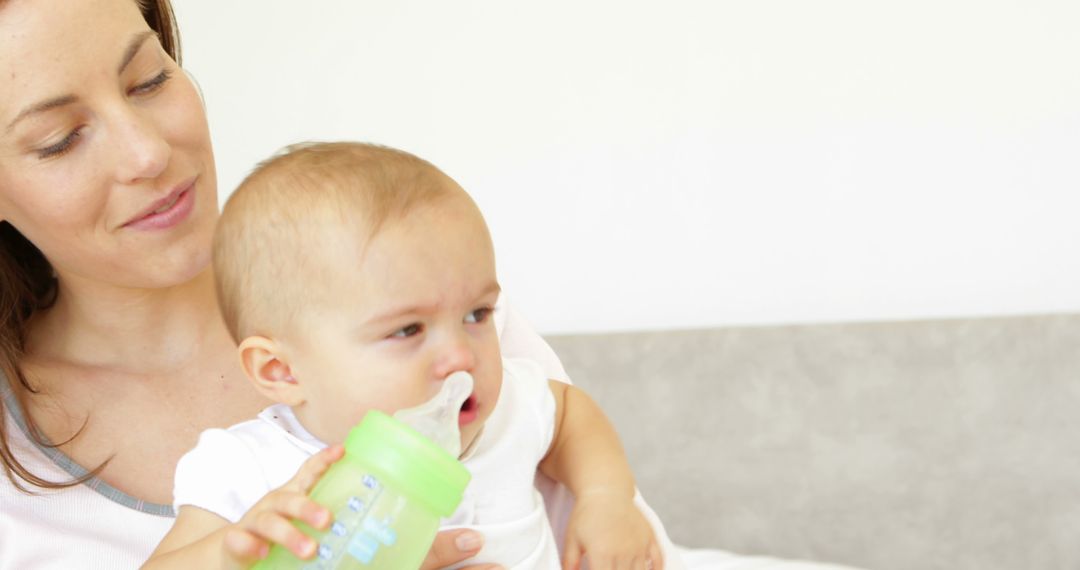 Mother Giving Bottle to Crying Baby - Free Images, Stock Photos and Pictures on Pikwizard.com