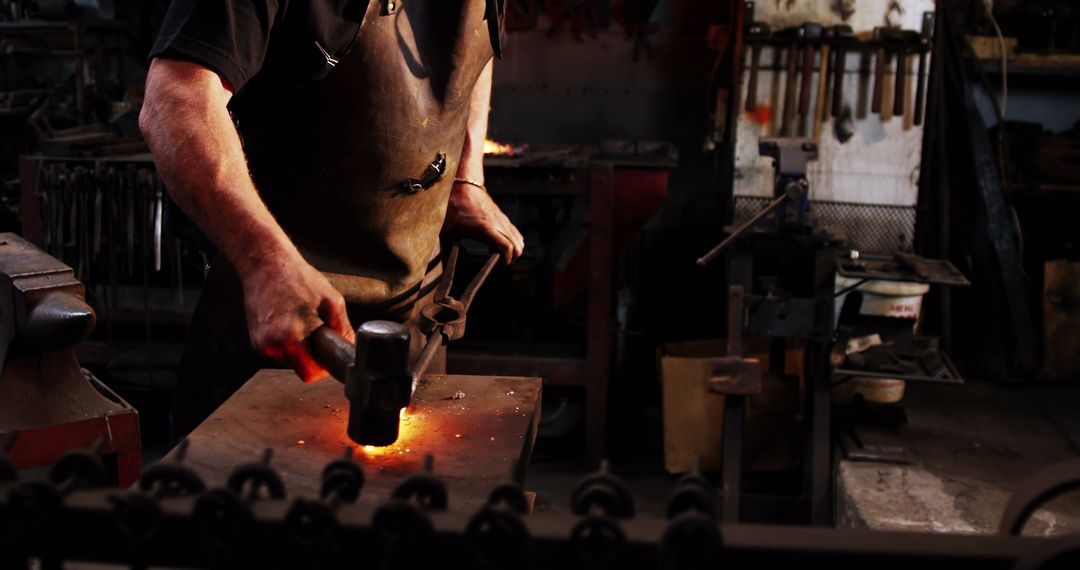 Blacksmith Hammering Red-Hot Metal in Workshop - Free Images, Stock Photos and Pictures on Pikwizard.com