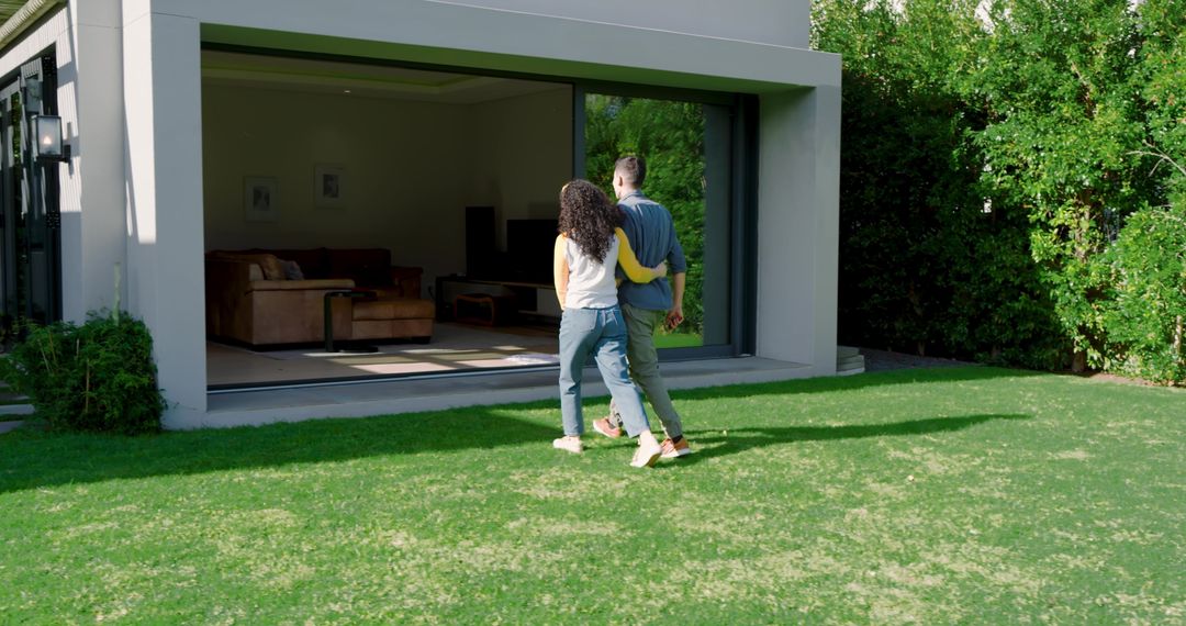 Couple Strolling Towards Modern Home Patio