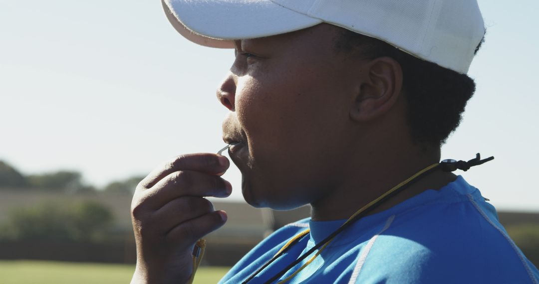 Sports coach blowing whistle during outdoor practice - Free Images, Stock Photos and Pictures on Pikwizard.com