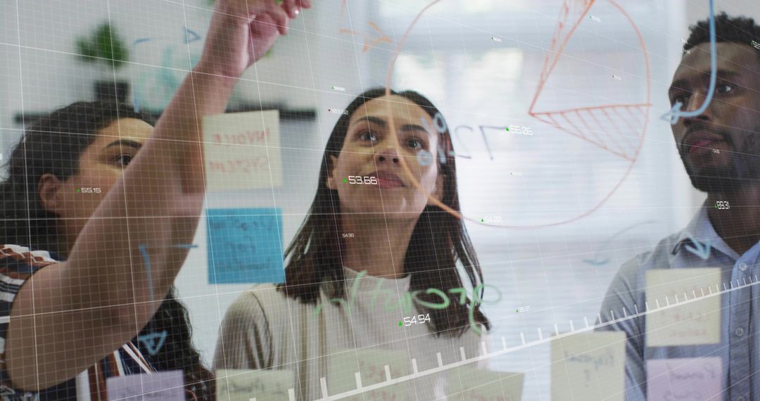 Diverse Team Collaborating on Glass Board Strategy in Modern Office