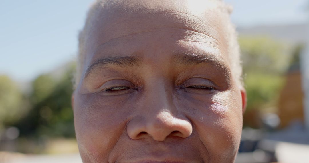 Close-up of Mature Person's Face with Eyes Closed Outdoors - Free Images, Stock Photos and Pictures on Pikwizard.com