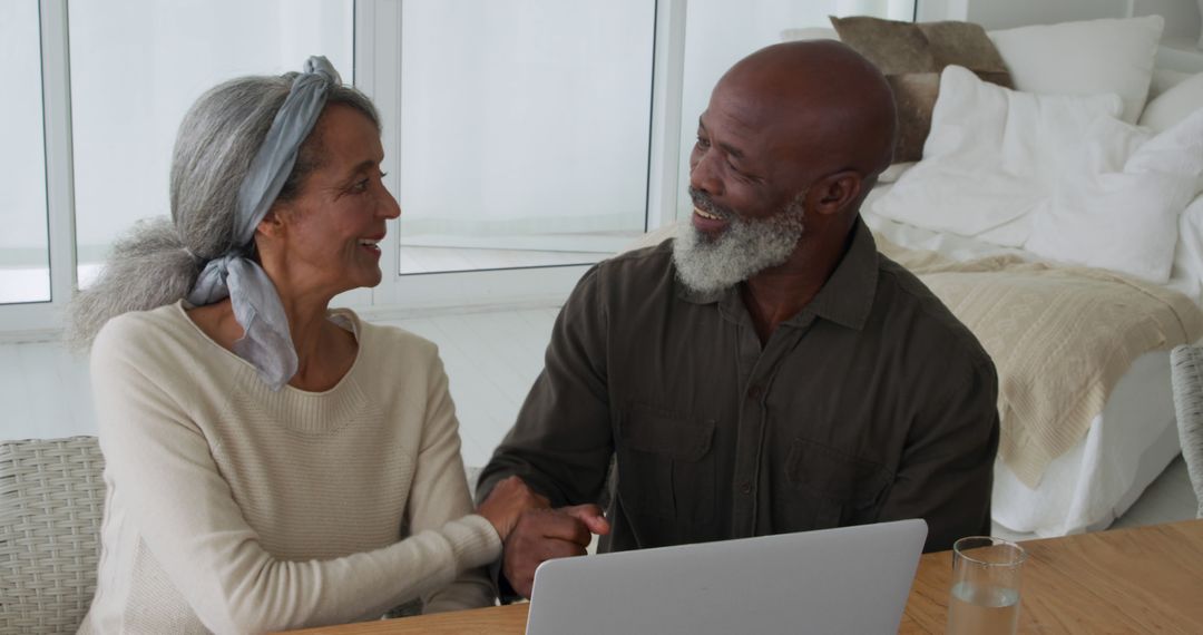 Senior Couple Enjoys Quality Time With Laptop at Home